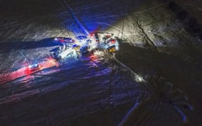An aerial view of emergency vehicles arriving near the site of the air crash in Ramensky district near Moscow.