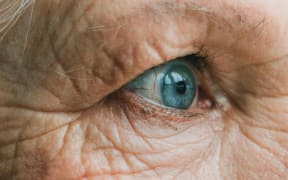 Close up of an elderly woman's blue eye