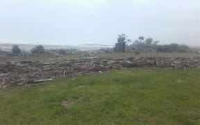 Andrew Wiffin's Hokitika dairy farm is covered in debris from storm surge