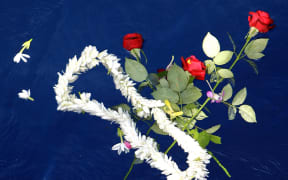Flowers are left at Air Moorea crash site