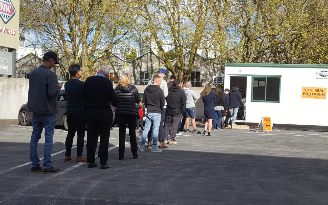 Advance voters queue out the door of this polling place at a supermarket in Auckland CBD.