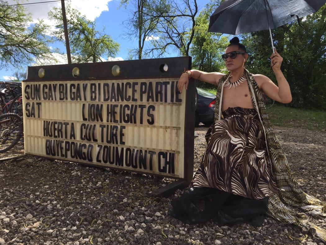 Mika in front of the sign at GayBiGayBi, Austin, 2015
