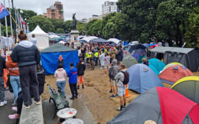 Protesters at Parliament after a night of heavy rain.