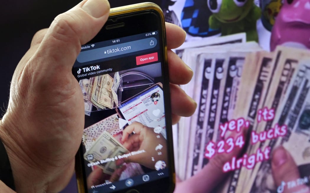 Manicured fingers meticulously place cash in transparent envelopes marked "food," "gas" and other categories, demonstrating in a TikTok video a retro technique for controlling what you spend that is newly popular with some money-conscious Americans.