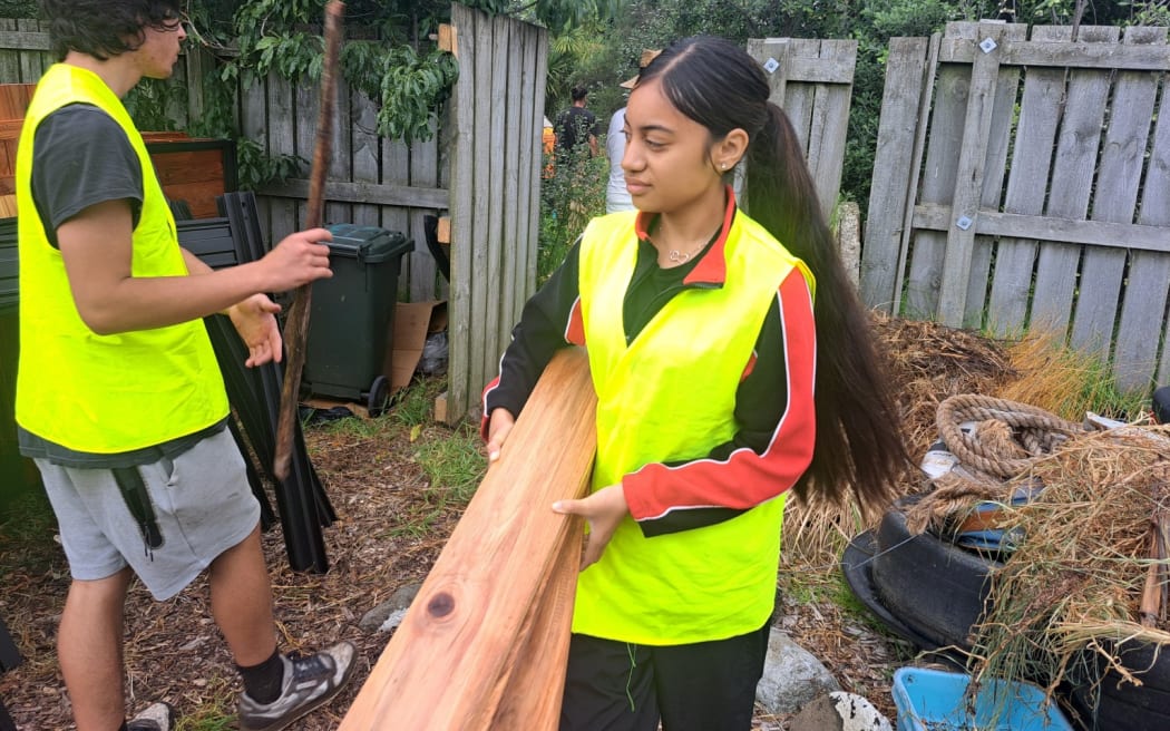 Māngere College student carrying wood for new compost bin.