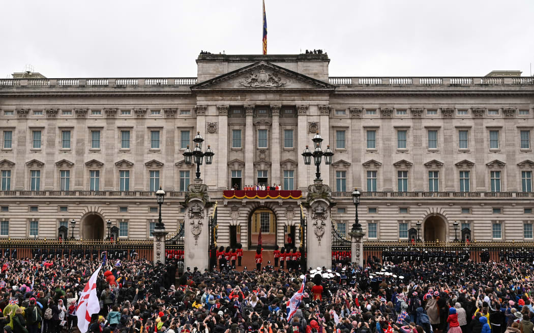 Crowds view members of the Royal Family on the Buckingham Palace balcony viewing the Royal Air Force fly-past in central London on May 6, 2023, after the coronations of Britain's King Charles III and Britain's Queen Camilla. - The set-piece coronation is the first in Britain in 70 years, and only the second in history to be televised. Charles will be the 40th reigning monarch to be crowned at the central London church since King William I in 1066. (Photo by Oli SCARFF / AFP)