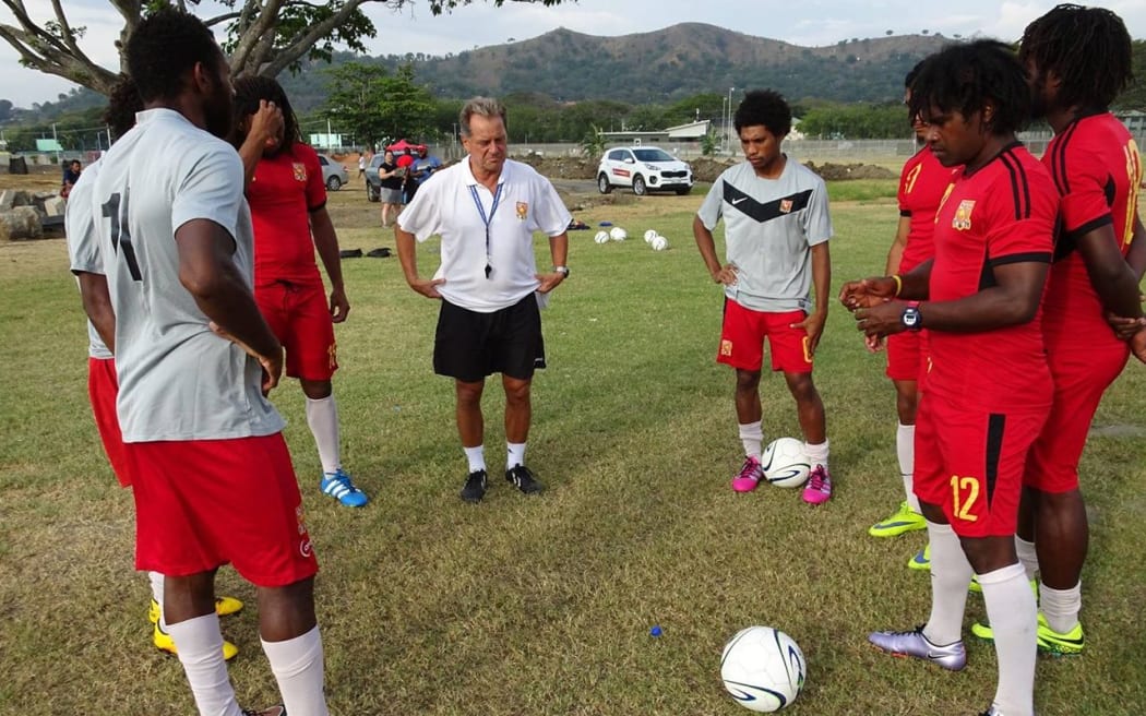 PNG coach Flemming Serritslev and players during a Kapuls training session.