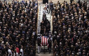 The casket of  the late US Senator John McCain, Republican of Arizona, is carried out after the National Memorial Service at the Washington National Cathedral in Washington, DC.
