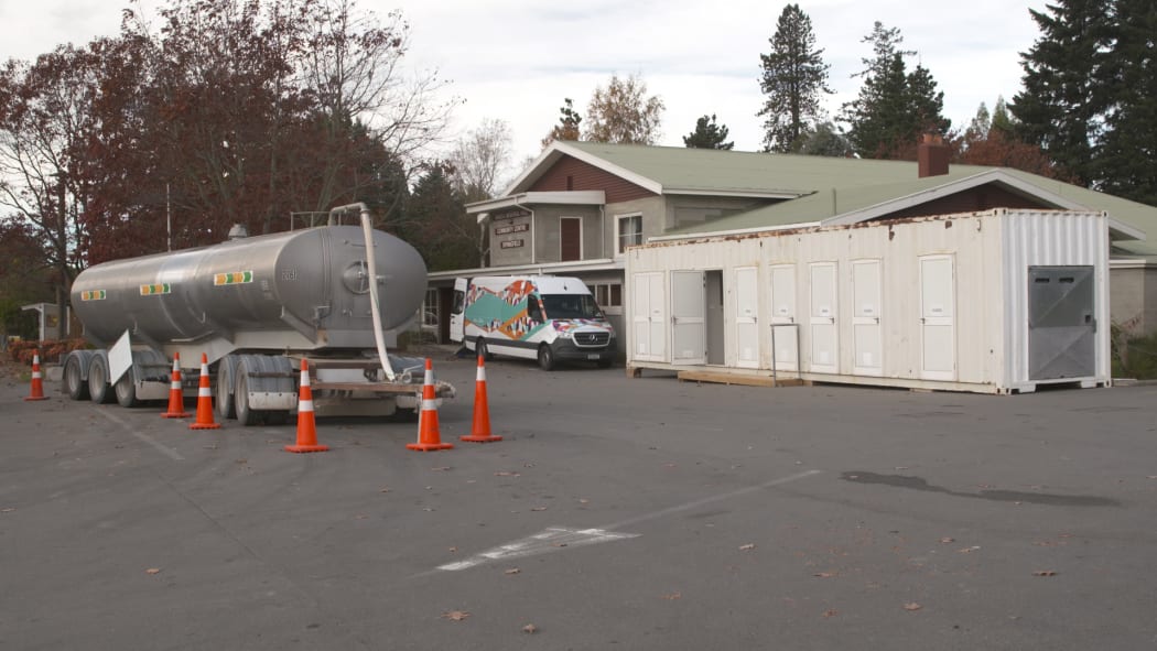A shower block has been set up outside the Springfield community hall due to persistent water quality issues in the town.