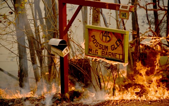 A bushfire burns outside a property near Taree, 350km north of Sydney on November 12, 2019.