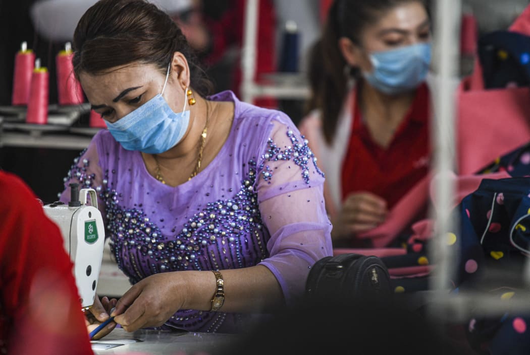 A worker is busy at a garment factory in Boyila Village of Shache County, northwest China's Xinjiang Region, May 23, 2020.