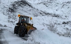 A snow plough at work on the Milford Road near Queenstown.