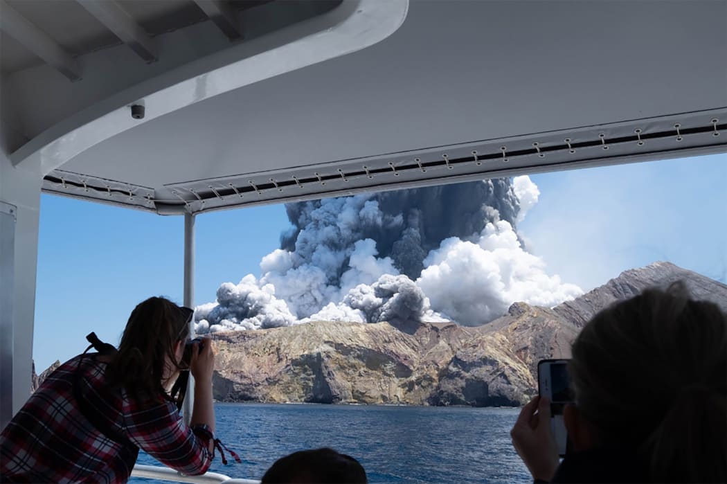 This handout photograph courtesy of Michael Schade shows the volcano on New Zealand's White Island spewing steam and ash moments after it erupted on December 9, 2019.