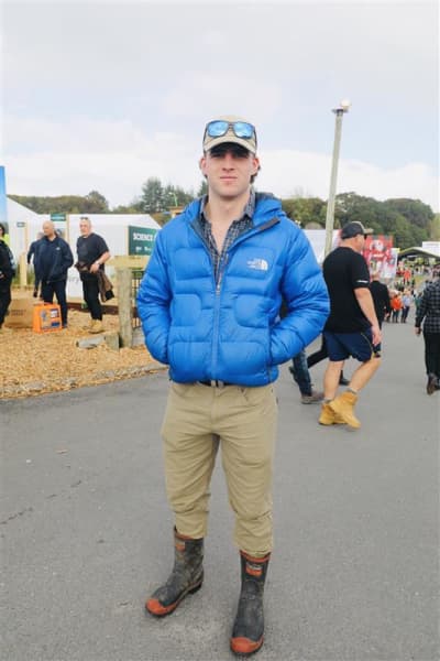 Alex is wearing Red Band gumboots, RM Williams belt, Stoney Creek shirt, and Hunters Element pants at Fieldays on 11 June, 2025.