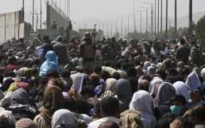 Crowds of Afghans gathered near the military part of the airport in Kabul on 20 August, 2021, hoping to flee from the country after the Taliban's military takeover of Afghanistan.
