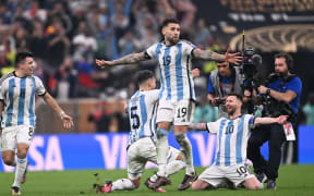 Argentina's forward #10 Lionel Messi (R) celebrates with Argentina's midfielder #05 Leandro Paredes (C), Argentina's defender #08 Marcos Acuna and Argentina's defender #19 Nicolas Otamendi after they won the Qatar 2022 World Cup final football match between Argentina and France.