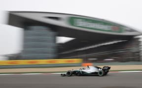Mercedes' British driver Lewis Hamilton takes a corner during the Formula One Chinese Grand Prix in Shanghai, 2019.