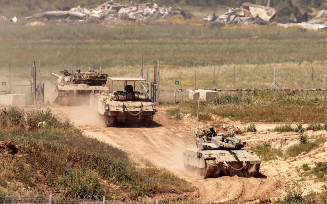 Israeli tanks move in an area along the border with the Gaza Strip and southern Israel on 4 April, 2024, amid the ongoing conflict in the Palestinian territory between Israel and the militant group Hamas.