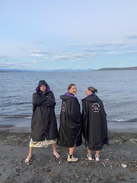 Swimmers in warm jackets after a swim in the cold water of Lake Taupō.