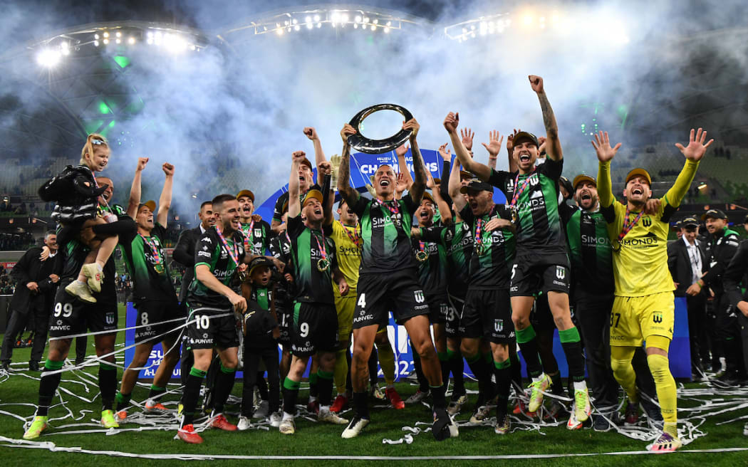 Western United players celebrate with the championship trophy during the A-League Grand Final.