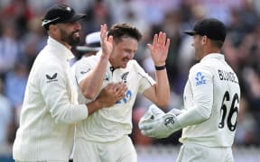 New Zealand bowler Nathan Smith celebrates with team mates Daryl Mitchell and Tom Blundell after running out England's Harry Brook.