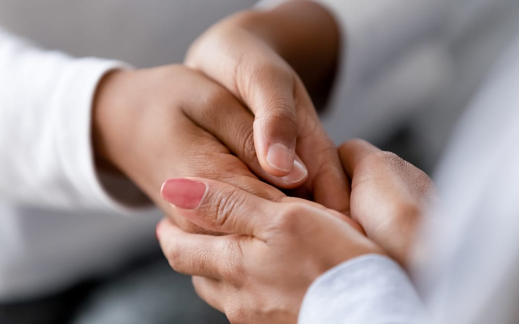 Close up caring African American mother holding child hands, showing love and support, black mum comforting, caressing kid, children protection concept, family enjoying moment together