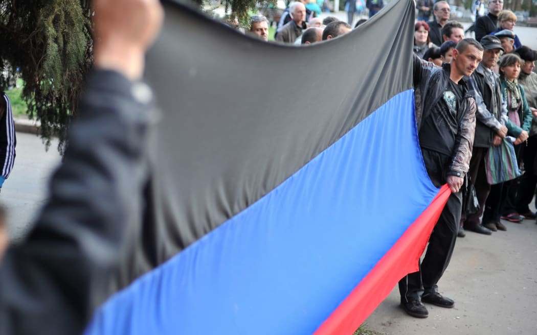 A flag of the 'Donetsk republic' is displayed outside a regional state building.