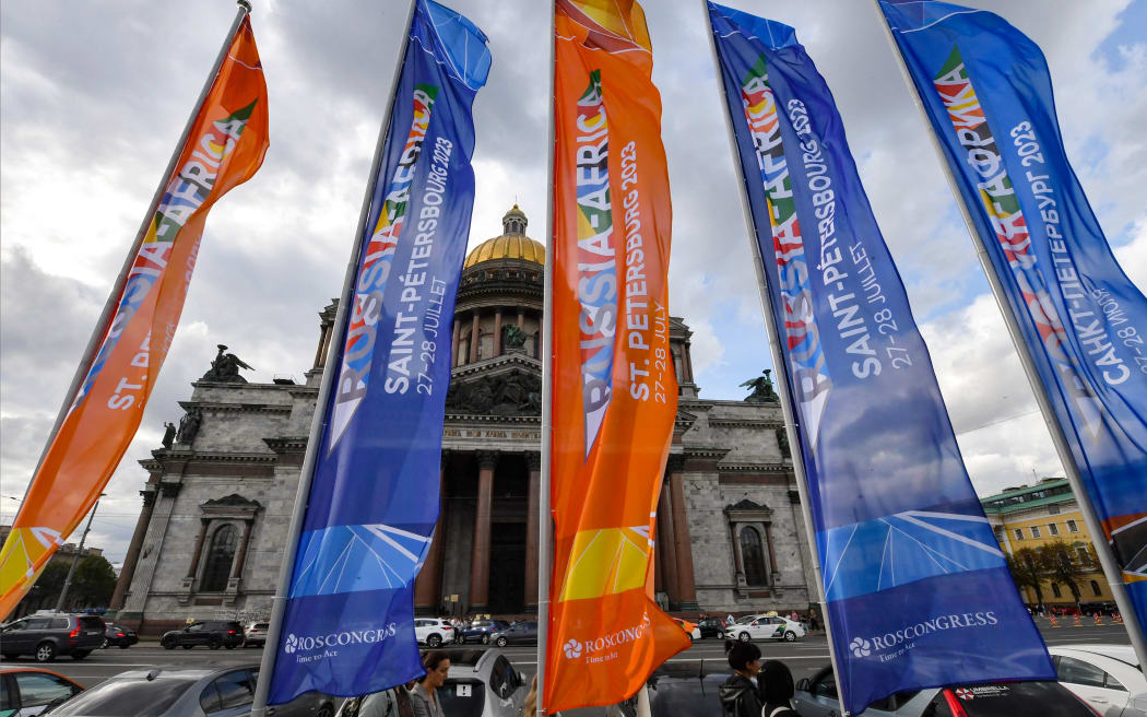 Flags promoting the upcoming second Russia-Africa summit are pictured outside St Isaac's Cathedral in Saint Petersburg on July 25, 2023. Russian President Vladimir Putin will discuss Ukraine with leaders of African countries, who will gather for a Russia-Africa summit hosted in Saint Petersburg later this week, the Kremlin said on July 25, 2023. (Photo by Olga MALTSEVA / AFP)