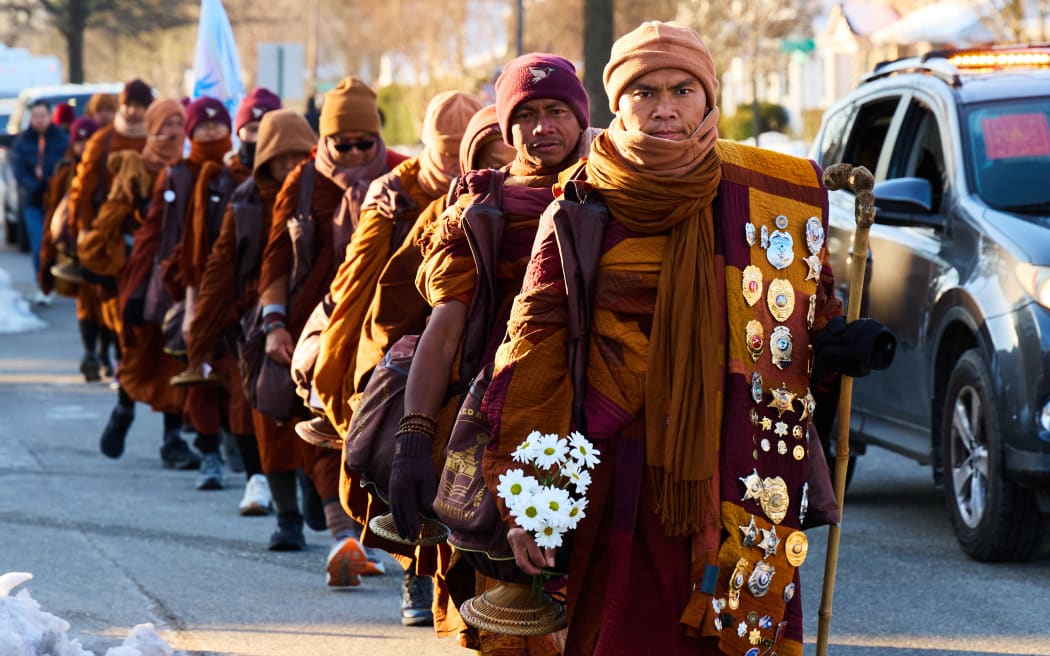 Led by Bhikkhu Pannakara (R), Buddhist monks participate in a "Walk for Peace" in Richmond, Virginia, on February 3, 2026. The group is walking from Fort Worth, Texas, to Washington, DC to promote peace, compassion and nonviolence. (Photo by Aaron Mathes / AFP)