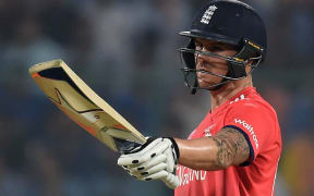 England's Jason Roy raises his bat after scoring a half century during the World T20 cricket semi-final match between England and New Zealand