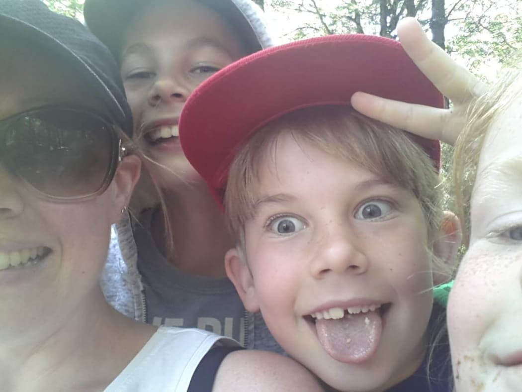 Kate Whale with her children, Cameron, left, James and Milly.