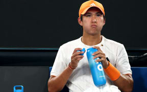 USA's Learner Tien drinks water between the games against Germany's Alexander Zverev during their men's singles quarter-final match under a close roof at the Australian Open tennis tournament in Melbourne.