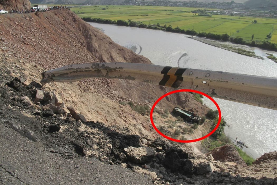 A bus is seen at the end of a ravine after veering off a mountain road and plunged into a ravine on the Panamerican road in southern Peru.