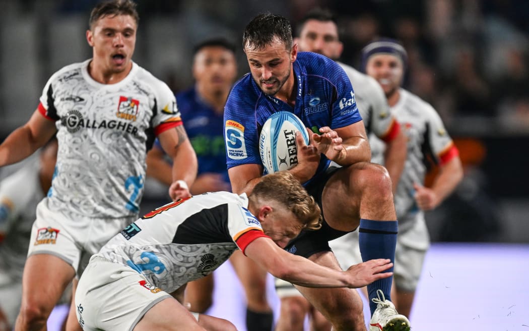 Damian McKenzie of the Chiefs attempts to tackle Harry Plummer.