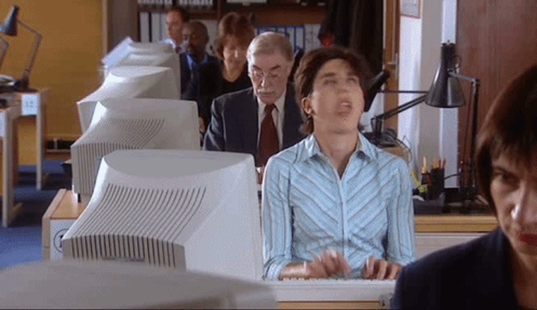 A gif of an unhappy woman typing