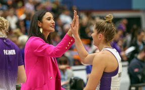 Stars coach Kiri Wills high fives one of her players.