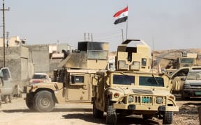 Humvees and vehicles of the combined Iraqi forces and Hashed Al-Shaabi (Popular Mobilization units) advance inside the town of Tal Afar, west of Mosul, after the Iraqi government announced the launch of the operation to retake it from Islamic State (IS) group control, on August 25, 2017.