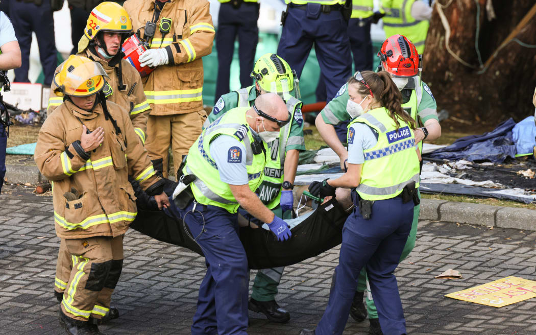 An injured police officer is carried away