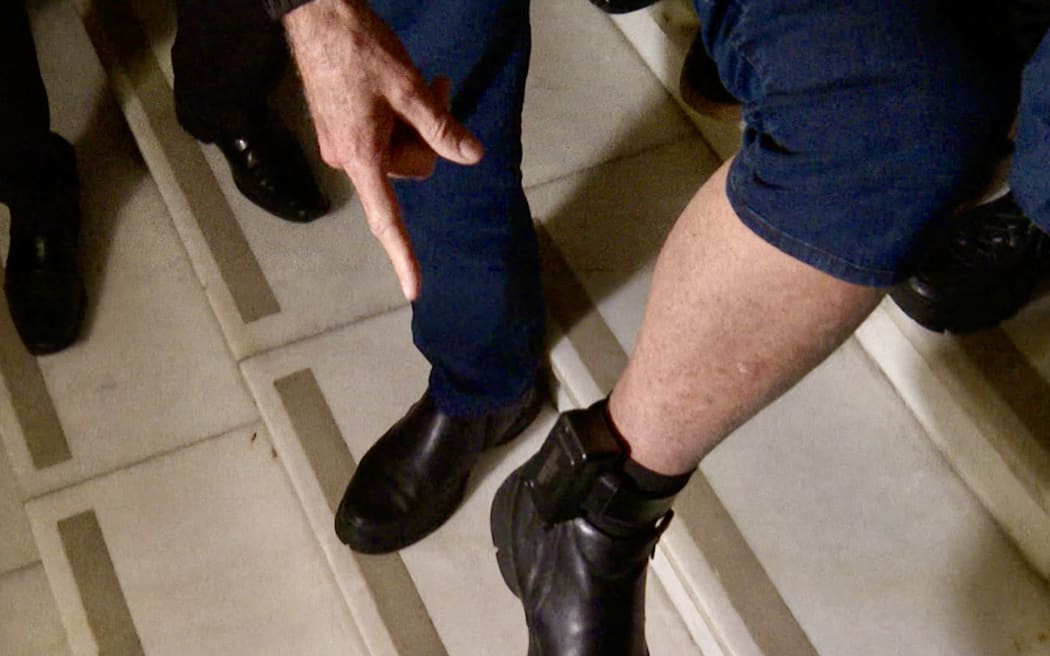 This frame grab from AFPTV video footage shows former Brazilian President Jair Bolsonaro with his ankle monitor as he leaves the National Congress in Brasilia on July 21, 2025. Bolsonaro must wear an electronic monitoring device as he awaits a verdict in his trial on charges of plotting a coup to nullify leftist President Luiz Inacio Lula da Silva's 2022 election victory. (Photo by JOSÉ OSORIO / AFPTV / AFP)