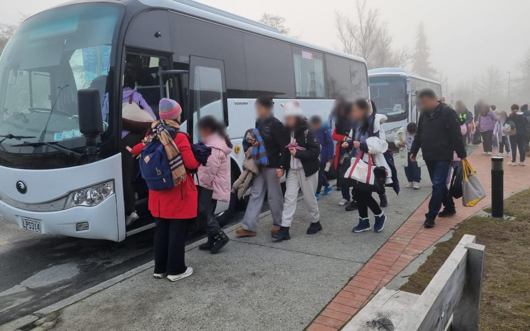 People involved in the Tekapō bus crashes leave Twizel Events Centre on new buses on 18 July, 2024.