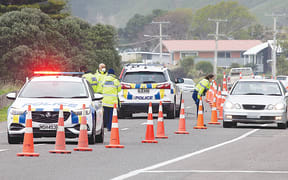 Police question drivers at a static checkpoint in Okitu, Wainui on Tuesday morning.