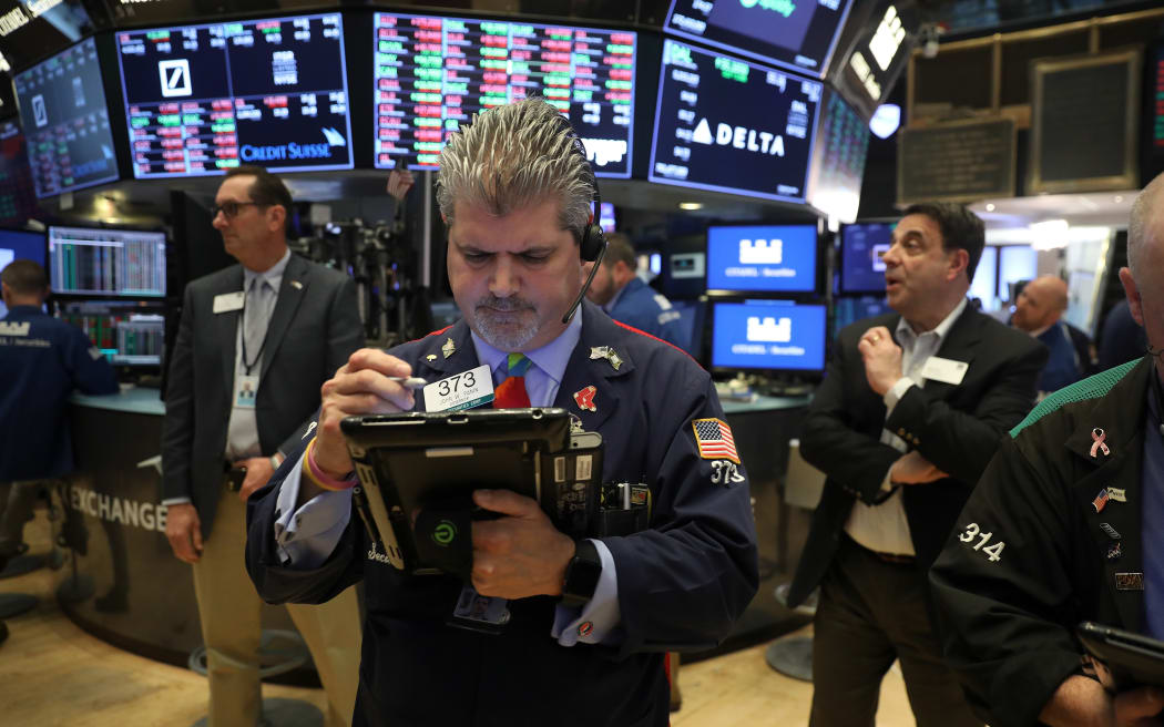 Traders on the floor of the New York Stock Exchange 15 June 2018.