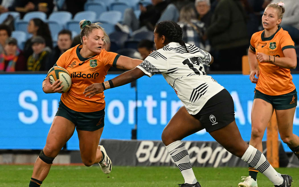 The Wallaroos Carys Dallinger (L) avoids a tackle from Fijiana's Bitila Tawake during the Women's Rugby match between the Australia’s Wallaroos and Fiji’s Fijiana at the Allianz Stadium in Sydney on May 20, 2023. (Photo by Saeed KHAN / AFP) / -- IMAGE RESTRICTED TO EDITORIAL USE - STRICTLY NO COMMERCIAL USE -- - -- IMAGE RESTRICTED TO EDITORIAL USE - STRICTLY NO COMMERCIAL USE --