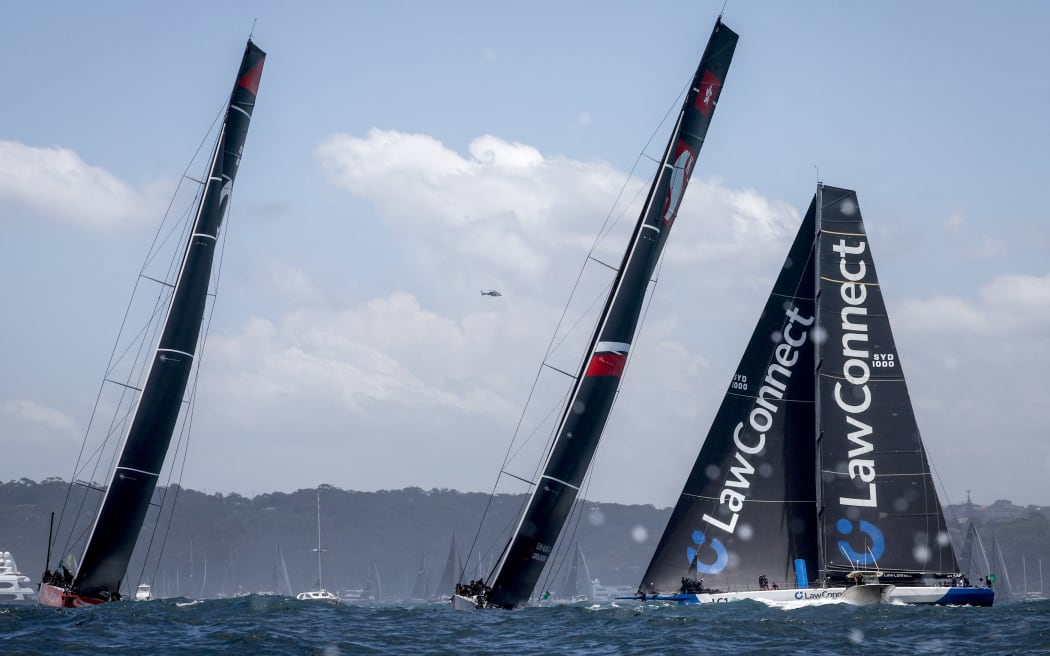 Yachts SHK Scallywag (C), Lawconnect (R), and Andoo Comanche compete during the start of the annual Sydney to Hobart yacht race on Boxing Day at Sydney Harbour on December 26, 2023.