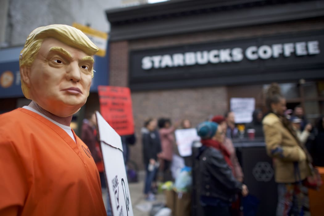 A protester demonstrates outside a Center City Starbucks after Philadelphia Police arrested two black men in the same Center City Starbucks.