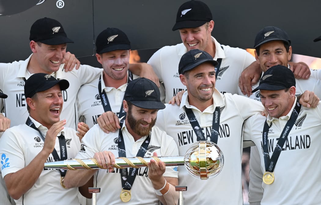 New Zealand's captain Kane Williamson (C) holds the winner's Mace as New Zealand players celebrate victory on the final day of the ICC World Test Championship Final between New Zealand and India at the Ageas Bowl in Southampton, southwest England on June 23, 2021.