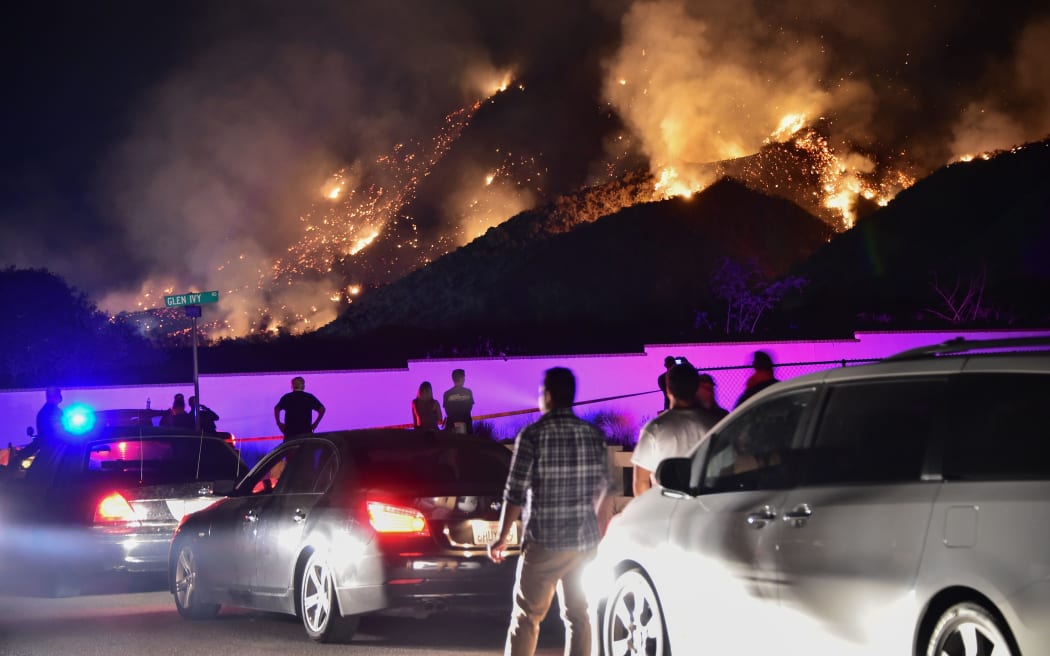 People watch flames from the Holy Fire outside Glen Ivy Hot Springs in Corona, California, southeast of Los Angeles, on August 10, 2018.