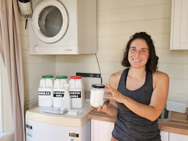 Sonja Barrish in her laundry with the borax, washing soda and baking soda she uses in her homemade cleaning products.