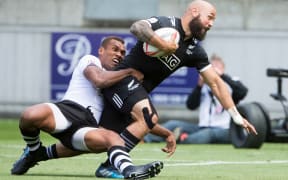 DJ Forbes battles his was to the try-line.