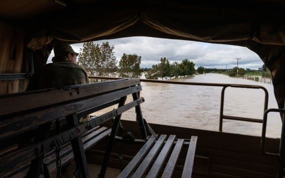 NZ Army Unimog travels through flooded roads near Puketapu, west of Napier, February 16.
